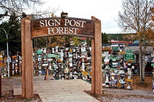 The sign forest is located on the side of the Alaska Highway 2